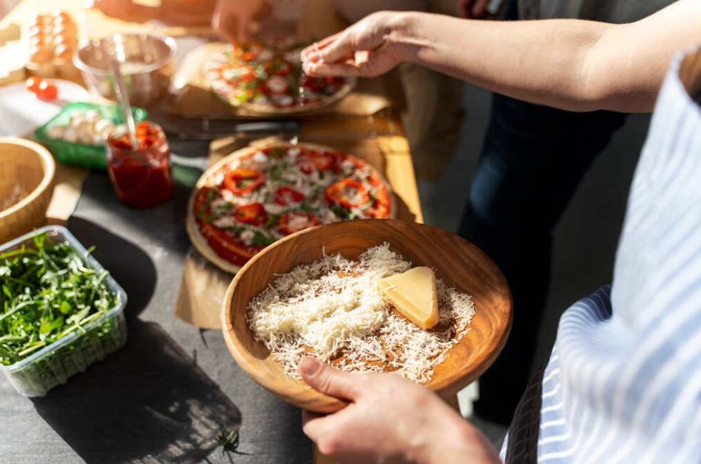 Adding Parmesan to pizza in the sunlit kitchen